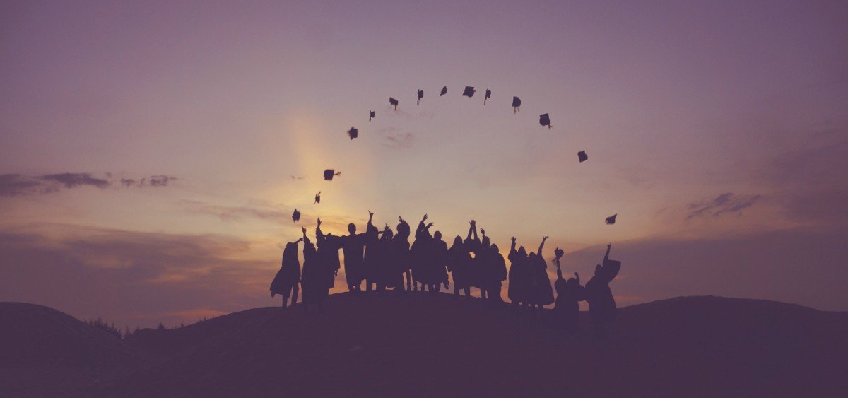 silhouette of students in graduation gowns