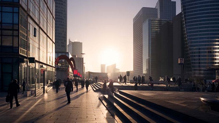 People walking outside the office building during sunset