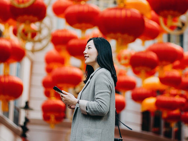 Women standing with a mobile