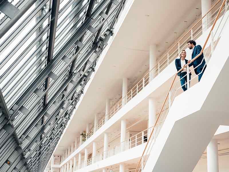 Men and women standing at staircase