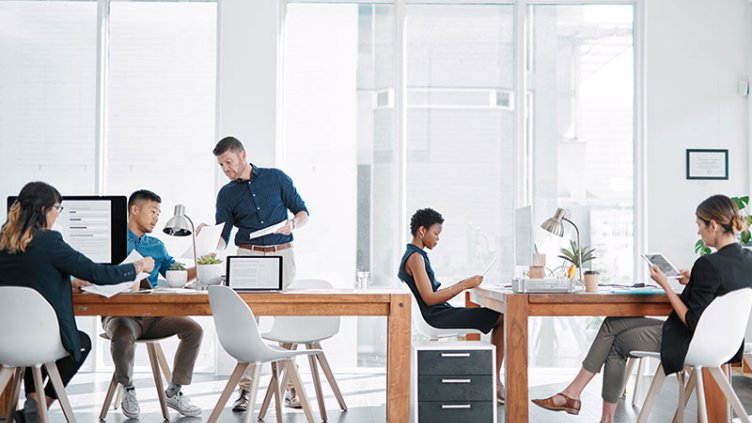Employees sharing deskspace in coworking space