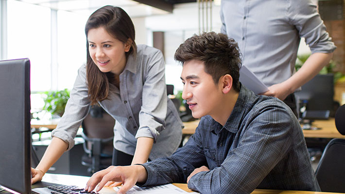 Two people working in desktop