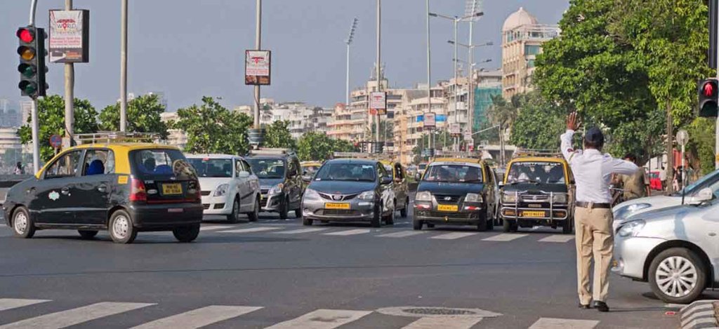 Traffic policeman stopping the cars by showing his hand on red light