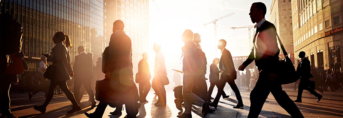 Commuters walking to work in the city at sunrise