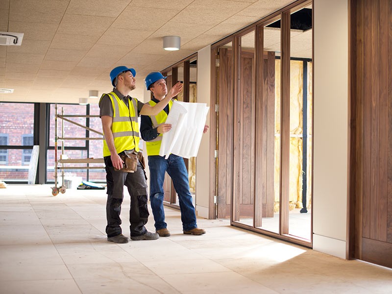 Two architects discussing the model of new real estate project