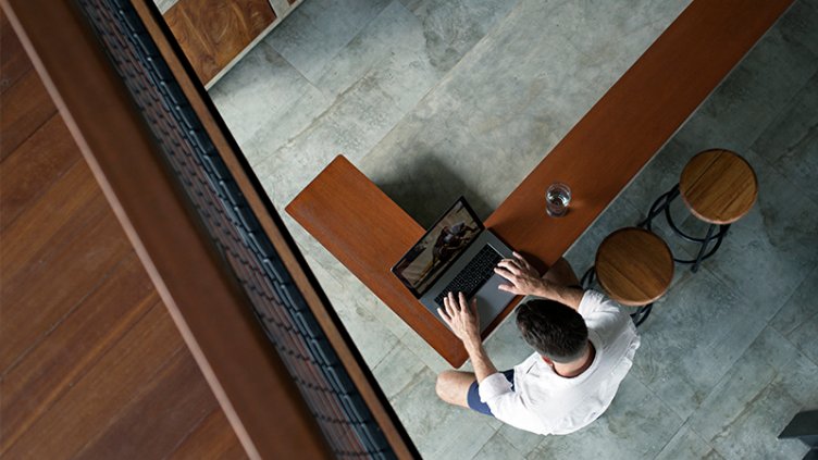 looking down on man using laptop